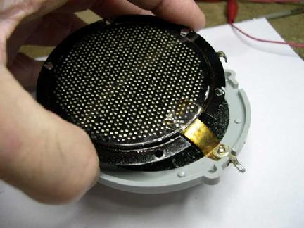 The grill with Mylar disc is fitted over repaired parts.